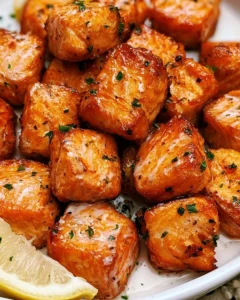Air-fried salmon bites served with dipping sauce on a plate